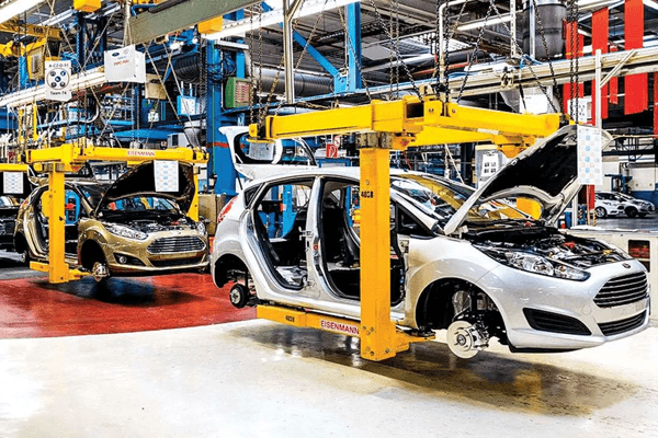 Cars moving through an automobile production line