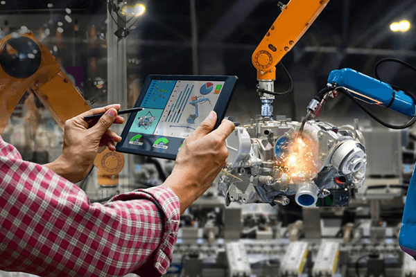 Manufacturing team using analytics alongside industrial robotics